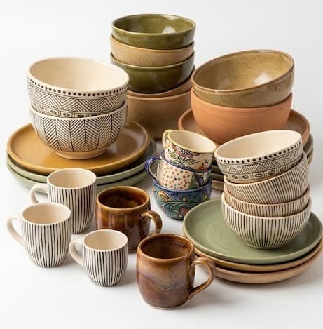 Handmade stoneware bowls and mugs in earthy green, brown and striped glazes