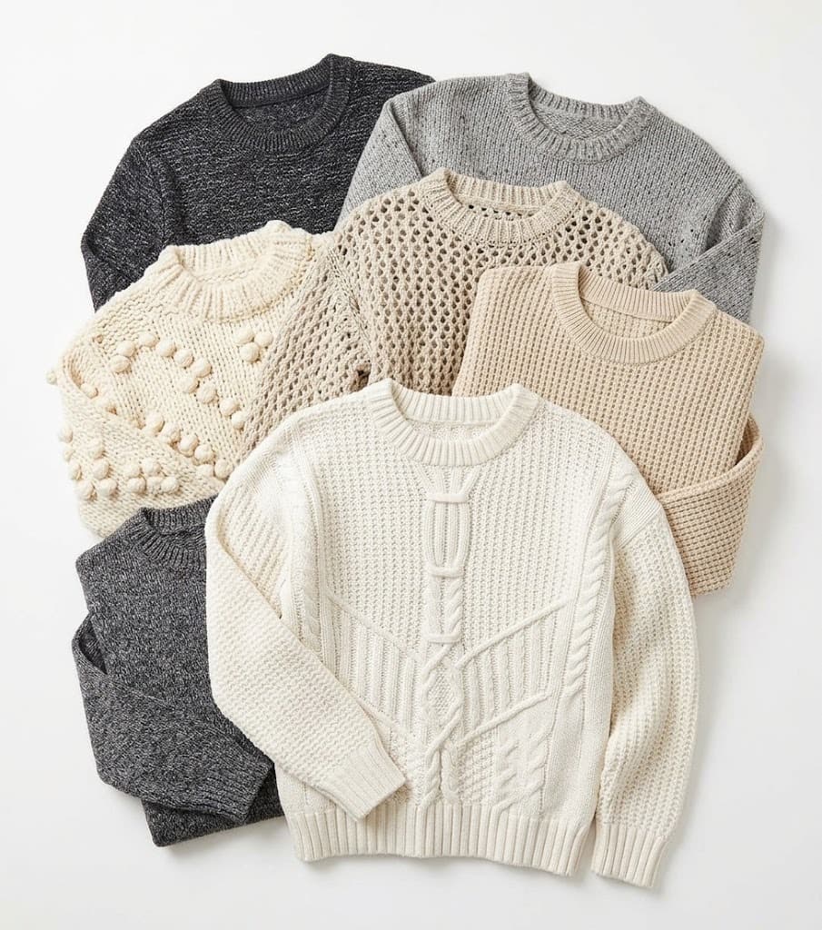 Assorted textured knit sweaters in charcoal, grey, cream and beige