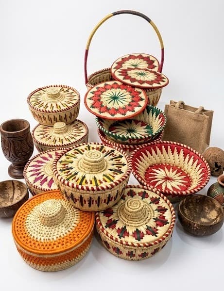 Painted lidded baskets in red, green and orange with wooden crafts