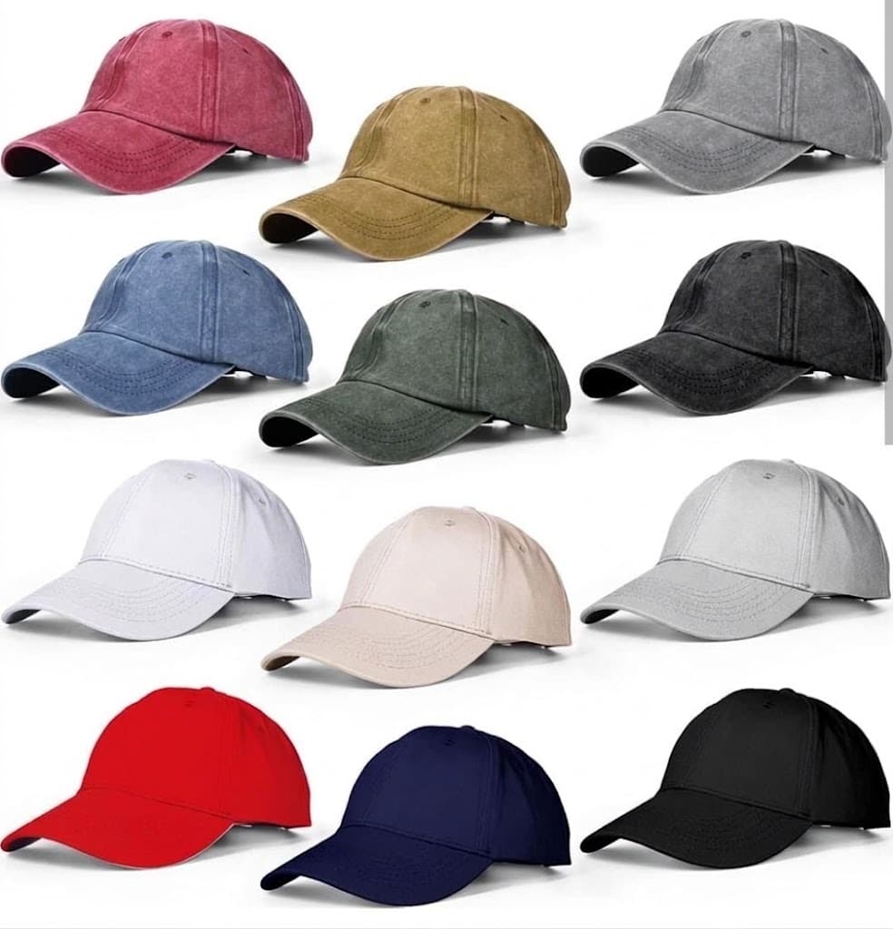 Twelve washed cotton baseball caps in assorted colors arranged in a grid on white background