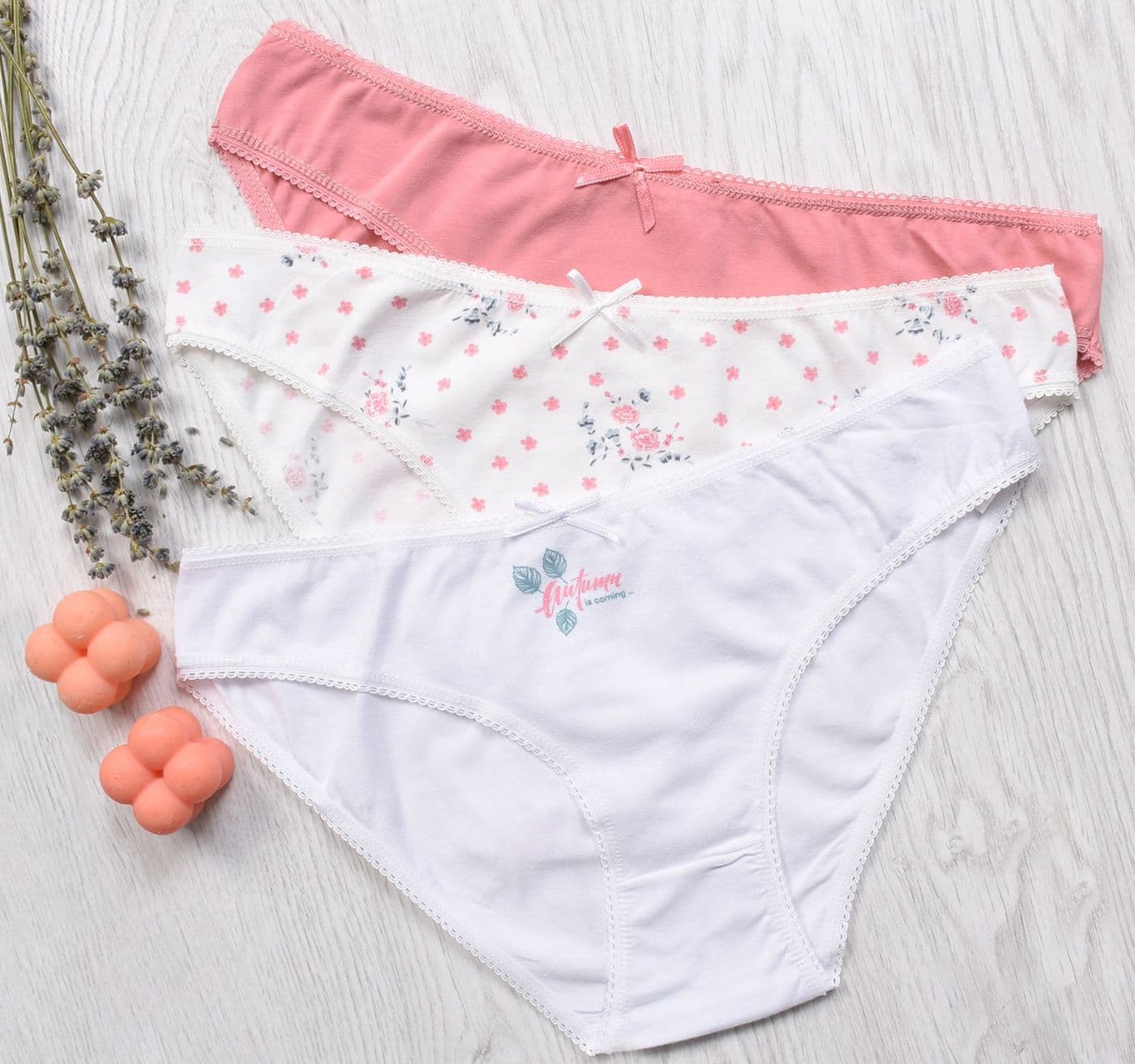 Three pairs of panties in pink, floral and white
