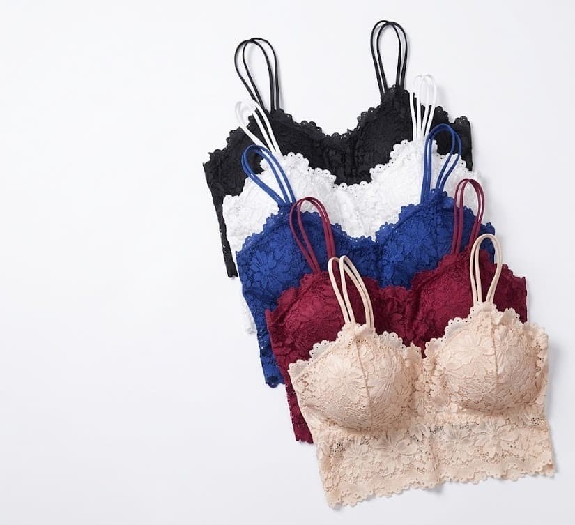 Fan of lace bralettes in black, white, blue, wine and beige