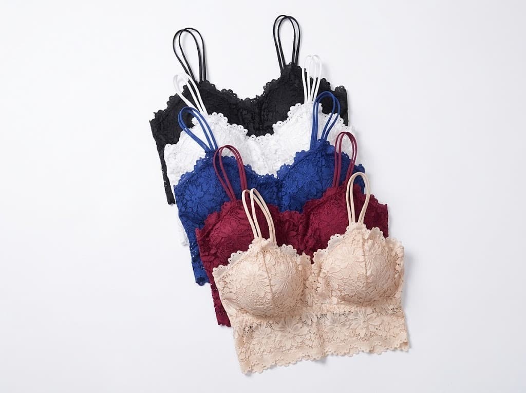 Fan of lace bralettes in black, white, blue, wine and beige