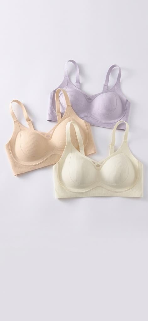 Three wirefree soft-cup bras in lilac, beige and cream