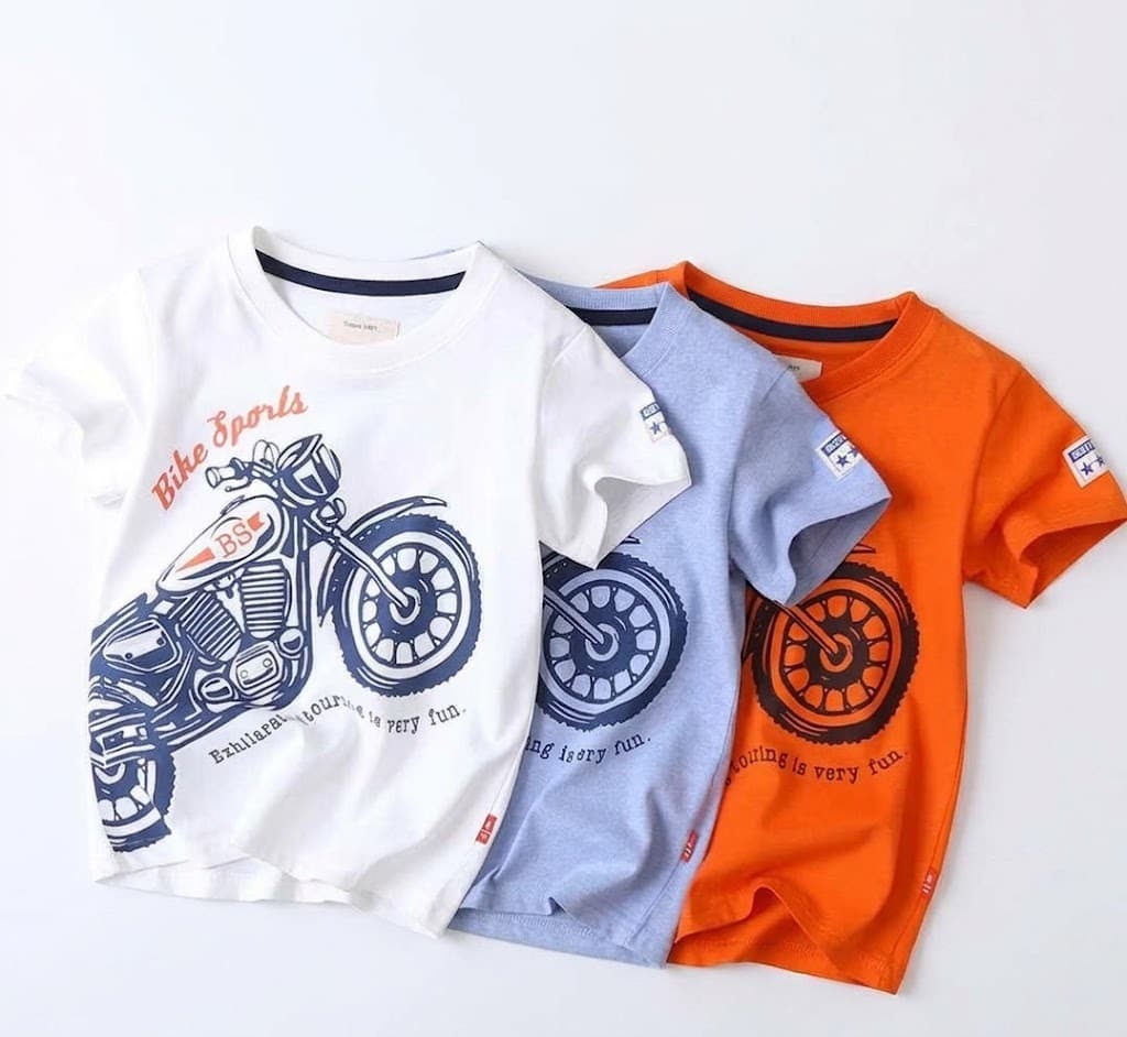Three boys' motorcycle print t-shirts in white, grey and orange