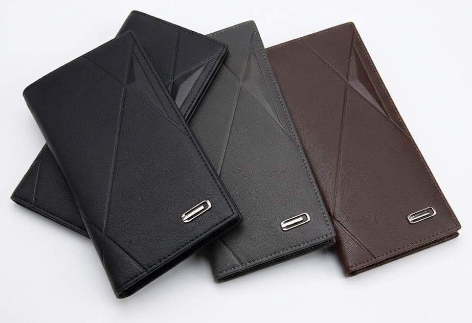 Three slim leather wallets with geometric embossed design in black, gray and brown