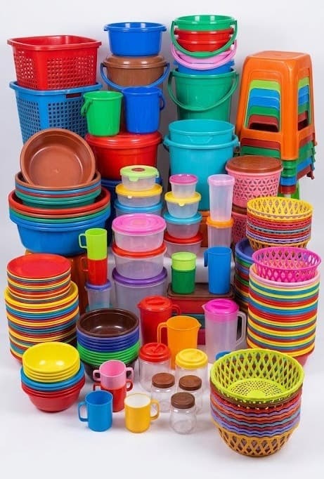 Stacked plastic baskets, buckets, mugs, jars and plates in bright colors