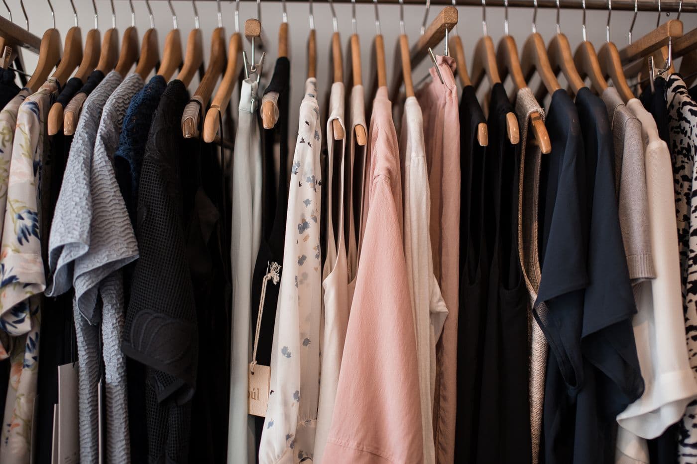 Assorted women's clothing on wooden hangers